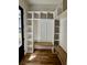 Bright mudroom with custom built-ins, wood bench, and hardwood floors creates an inviting transition space at 2611 Charlesgate Ave, Decatur, GA 30030