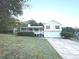 Charming home featuring a covered porch, two-car garage, and well-maintained landscaping at 413 Kenny Ln, Temple, GA 30179