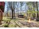 Backyard view featuring a shed and a cozy fire pit at 2420 Green Rd, Loganville, GA 30052
