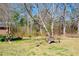 An expansive backyard featuring mature trees, rustic swing, and tire obstacles for outdoor fun at 2420 Green Rd, Loganville, GA 30052