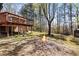 Backyard view featuring an elevated deck and a cozy fire pit at 2420 Green Rd, Loganville, GA 30052