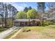Charming single-story home features a mix of brick and siding, complemented by a well-maintained front lawn at 2420 Green Rd, Loganville, GA 30052