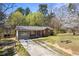 A charming single-story house, with a brick and siding exterior, accented by green lawn and trees at 2420 Green Rd, Loganville, GA 30052