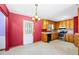 Cozy kitchen showcasing wood cabinets, laminate countertops, stainless-steel appliances, and an open door to a private backyard at 2420 Green Rd, Loganville, GA 30052