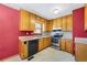 Cozy kitchen showcasing wood cabinets, laminate countertops and stainless-steel appliances at 2420 Green Rd, Loganville, GA 30052