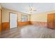 Inviting space featuring wood-look flooring, wood-paneled walls, and a ceiling fan for added comfort at 2420 Green Rd, Loganville, GA 30052