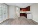 Finished basement with wet bar, wood floors, and bright windows at 940 Waters Reach Ct, Alpharetta, GA 30022