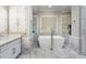 Luxury bathroom featuring a modern tub, marble accents, and vanity with sink at 940 Waters Reach Ct, Alpharetta, GA 30022