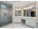 Primary bathroom offering a glass shower, elegant counters, and dual sinks at 940 Waters Reach Ct, Alpharetta, GA 30022