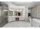 Bathroom with marble-like floors, an elegant tub, shower and and sinks at 940 Waters Reach Ct, Alpharetta, GA 30022