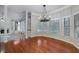 Large dining room showcasing hardwood floors, a modern chandelier, wainscoting, and expansive windows at 940 Waters Reach Ct, Alpharetta, GA 30022