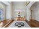 Spacious foyer with hardwood floors, black and white tile inlay, and white trim leading to the living room at 940 Waters Reach Ct, Alpharetta, GA 30022