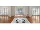 Bright foyer showcasing hardwood floors, black and white tile inlay, and white trim throughout at 940 Waters Reach Ct, Alpharetta, GA 30022