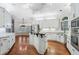 Spacious kitchen featuring white cabinetry, stainless steel appliances, and a kitchen island with bar seating at 940 Waters Reach Ct, Alpharetta, GA 30022