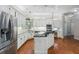 Large kitchen showcasing white cabinetry, stainless steel appliances, and a center kitchen island at 940 Waters Reach Ct, Alpharetta, GA 30022