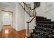 Elegant staircase featuring wood handrail, white spindles, and patterned carpeting at 940 Waters Reach Ct, Alpharetta, GA 30022