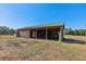 Exterior view of a rustic barn featuring a metal roof and open design at 1201 Keencheefoonee Rd, Rutledge, GA 30663