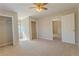 Spacious bedroom with neutral carpet, ceiling fan and walk-in closet at 1201 Keencheefoonee Rd, Rutledge, GA 30663