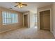 Spacious bedroom with neutral carpet, ceiling fan and two closets at 1201 Keencheefoonee Rd, Rutledge, GA 30663