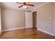 Spacious bedroom showcasing hardwood floors, ceiling fan, and a walk-in closet at 1201 Keencheefoonee Rd, Rutledge, GA 30663