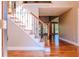 Inviting entryway with hardwood floors and staircase featuring decorative iron spindles at 1201 Keencheefoonee Rd, Rutledge, GA 30663
