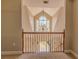 Hallway looking towards staircase with chandelier and railing at 1201 Keencheefoonee Rd, Rutledge, GA 30663