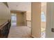 Upstairs hallway featuring carpeting and views of a large window and staircase at 1201 Keencheefoonee Rd, Rutledge, GA 30663