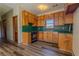 Traditional kitchen featuring wooden cabinets, green countertops, and modern appliances at 1201 Keencheefoonee Rd, Rutledge, GA 30663