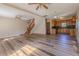 Open-concept living room with wood floors seamlessly connected to the kitchen and staircase at 1201 Keencheefoonee Rd, Rutledge, GA 30663