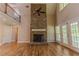Bright living room with a stone fireplace, high ceilings, and French doors to the outside at 1201 Keencheefoonee Rd, Rutledge, GA 30663