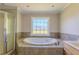 Bathroom features a luxurious soaking tub with tile surround at 1201 Keencheefoonee Rd, Rutledge, GA 30663