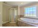 Bathroom offers a soaking tub, separate shower, and large window at 1201 Keencheefoonee Rd, Rutledge, GA 30663
