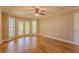 Light-filled main bedroom features hardwood floors and a ceiling fan at 1201 Keencheefoonee Rd, Rutledge, GA 30663