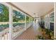 Wide covered porch with white railing and scenic views of a lush, green landscape at 1201 Keencheefoonee Rd, Rutledge, GA 30663