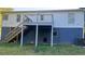 View of the backyard with a raised deck, stairs, a door to the lower level, and an air conditioning unit at 698 Rocky Plains Rd, Covington, GA 30016