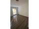 Bright bedroom with hardwood floors and a window bringing in natural light at 698 Rocky Plains Rd, Covington, GA 30016