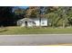 Charming single-story home featuring a minimalist landscape and surrounded by mature trees at 698 Rocky Plains Rd, Covington, GA 30016