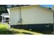 Exterior side view of a house, showing the siding, power meter and a small window at 698 Rocky Plains Rd, Covington, GA 30016