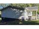 Side view of the exterior of the house with a partly visible porch, showing the siding and the foundation at 698 Rocky Plains Rd, Covington, GA 30016