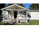 Quaint home featuring a covered front porch with gray railing, offering a welcoming entrance at 698 Rocky Plains Rd, Covington, GA 30016