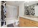 Modern bathroom featuring a shower, granite countertop vanity, and geometric wall design at 860 Peachtree Ne St # 1903, Atlanta, GA 30308