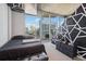 Modern bedroom with a city view, geometric wall accents, and stylish furniture at 860 Peachtree Ne St # 1903, Atlanta, GA 30308