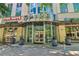 Inviting building entrance with modern architecture, signage, and nearby storefronts at 860 Peachtree Ne St # 1903, Atlanta, GA 30308
