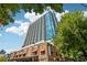 Striking exterior view of a modern high-rise building with balconies and commercial space at 860 Peachtree Ne St # 1903, Atlanta, GA 30308
