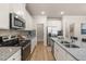 Modern kitchen with white cabinets, granite countertops, and stainless steel appliances at 495 Hancock Se Dr, Atlanta, GA 30354