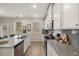 Modern kitchen with white cabinets, granite countertops, and stainless steel appliances at 495 Hancock Se Dr, Atlanta, GA 30354