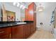 Bathroom with dark granite counters, and wooden cabinets and floors at 400 17Th Nw St # 2120, Atlanta, GA 30363