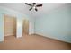 Bedroom with neutral carpet, ceiling fan, closet and blue accent wall at 400 17Th Nw St # 2120, Atlanta, GA 30363