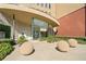Stylish building entrance features modern architecture, landscaped greenery, and unique spherical stone accents at 400 17Th Nw St # 2120, Atlanta, GA 30363