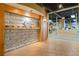 Aesthetic design in gym hallway features stone wall decor, modern lighting, and clear views of the fitness equipment at 400 17Th Nw St # 2120, Atlanta, GA 30363